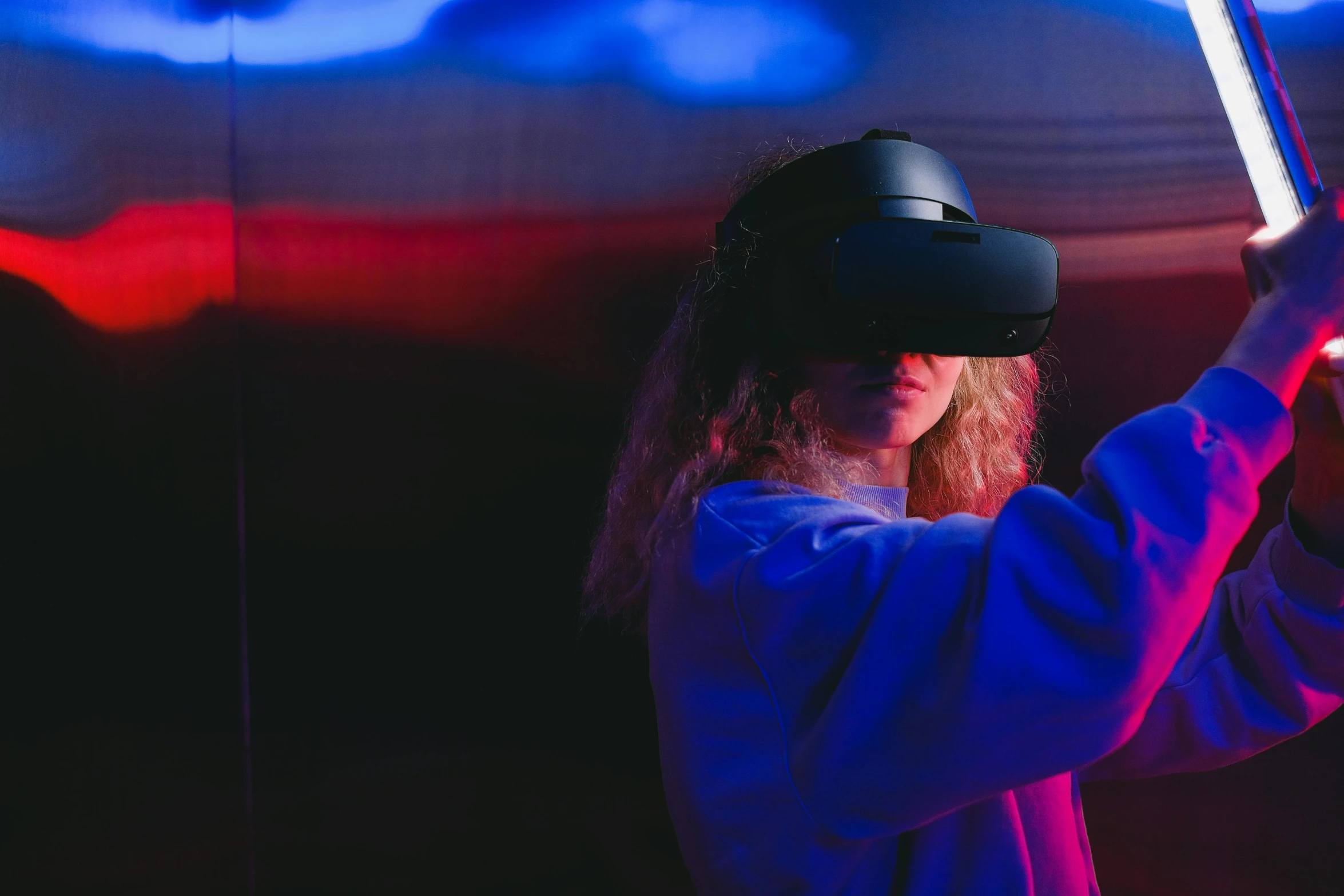 a woman in a white shirt holding a red and blue light saber, a hologram, unsplash, interactive art, wearing a vr headset, avatar image