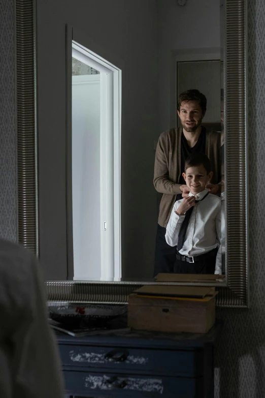 a man that is standing in front of a mirror, with a kid, hotel room, denis villeneuve movie still, groom