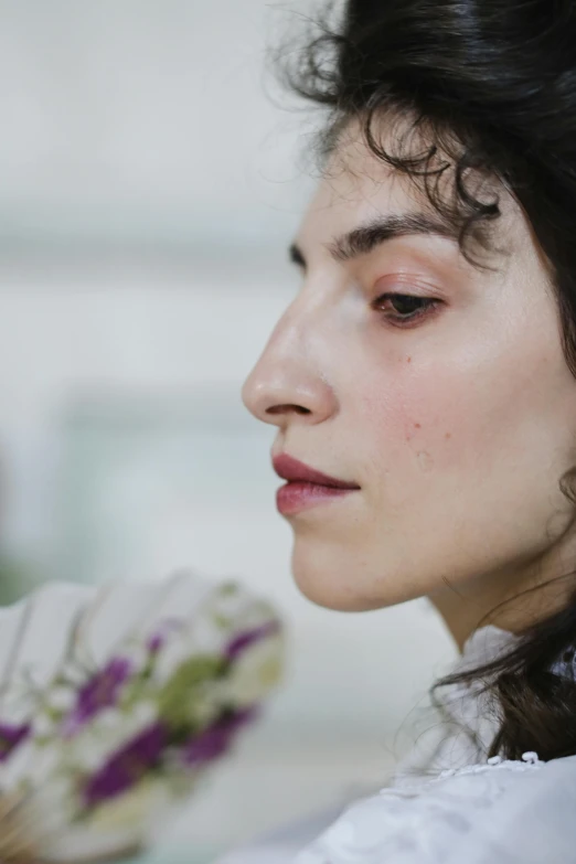 a close up of a person holding a fan, inspired by Elsa Bleda, trending on pexels, hyperrealism, side portrait of imogen poots, thick jawline, woman with black hair, profile image