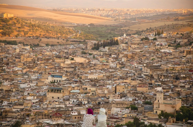 a couple of people standing on top of a hill, trending on unsplash, renaissance, moroccan city, zoomed in, dezeen, aida muluneh