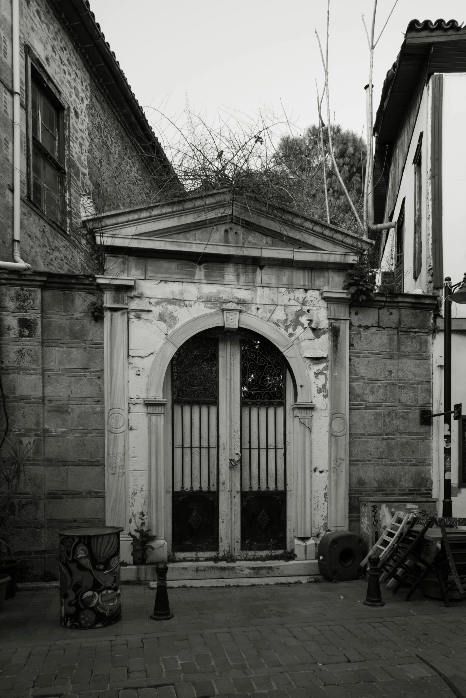 a black and white photo of an old building, a black and white photo, by Albert Welti, large gate, style of atget, ( ( photograph ) ), square