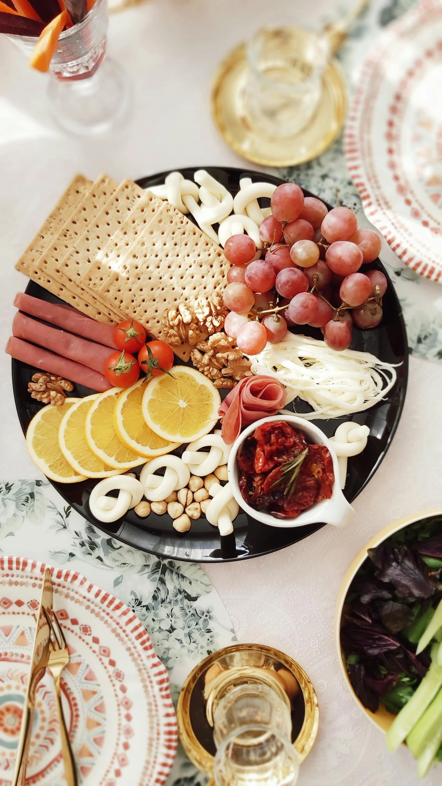 a close up of a plate of food on a table, cheese and salami on the table, thumbnail, decorations, no cropping