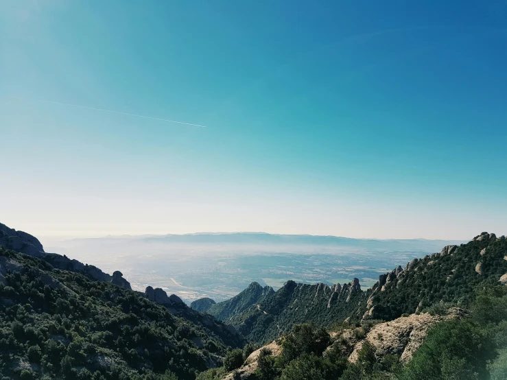 a view of the mountains from the top of a mountain, pexels contest winner, les nabis, monserrat gudiol, blue and clear sky, thumbnail, slightly sunny