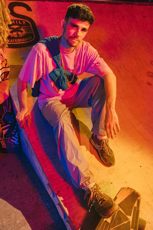 a man and a woman sitting on a skateboard, inspired by David LaChapelle, trending on pexels, neo-fauvism, soft neon lighting, sitting on the floor, outfit photograph, lil peep