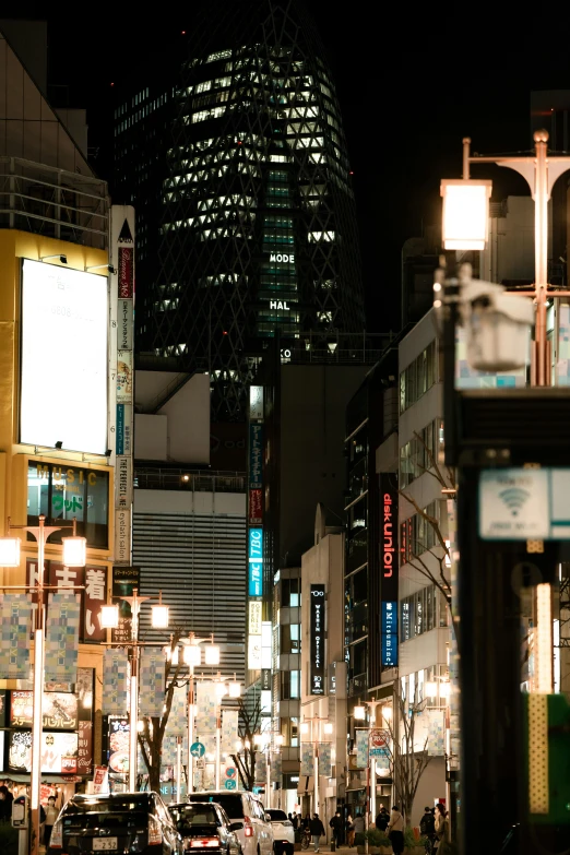 a city street filled with lots of traffic next to tall buildings, a picture, tokyo at night, street lighting, banner, square