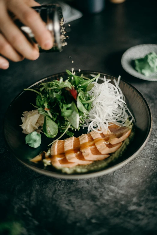 a close up of a plate of food on a table, inspired by Nishida Shun'ei, trending on unsplash, lush greens, asian man, bowl, duck