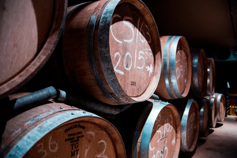 a bunch of wine barrels stacked on top of each other, a portrait, unsplash, te pae, profile image, 2015, cellar