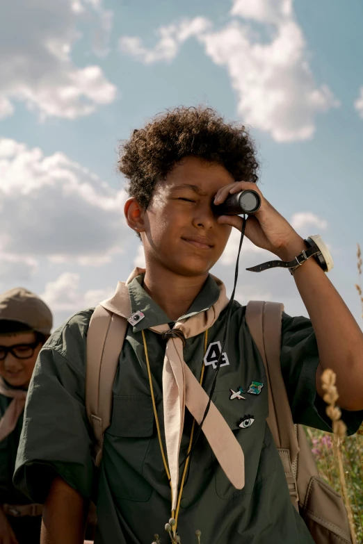 a boy scout looking through a pair of binoculars, by Jan Tengnagel, happening, he looks like tye sheridan, imaan hammam, in a wheat field, ( ( theatrical ) )