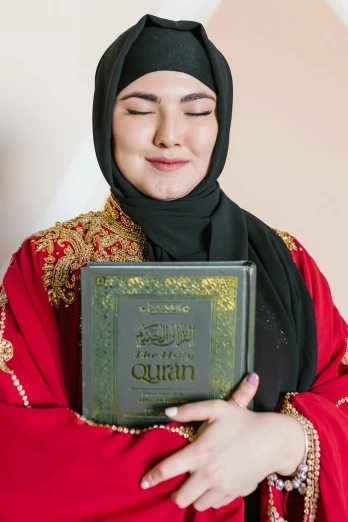 a woman in a hijab holding a quran, an album cover, pexels contest winner, wearing red attire, all overly excited, - 8, asian face
