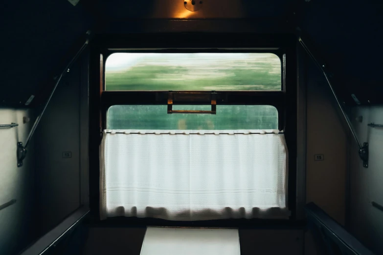 a view out the window of a train car, unsplash, romanticism, curtain, fan favorite, hotel room, 1 7 9 5