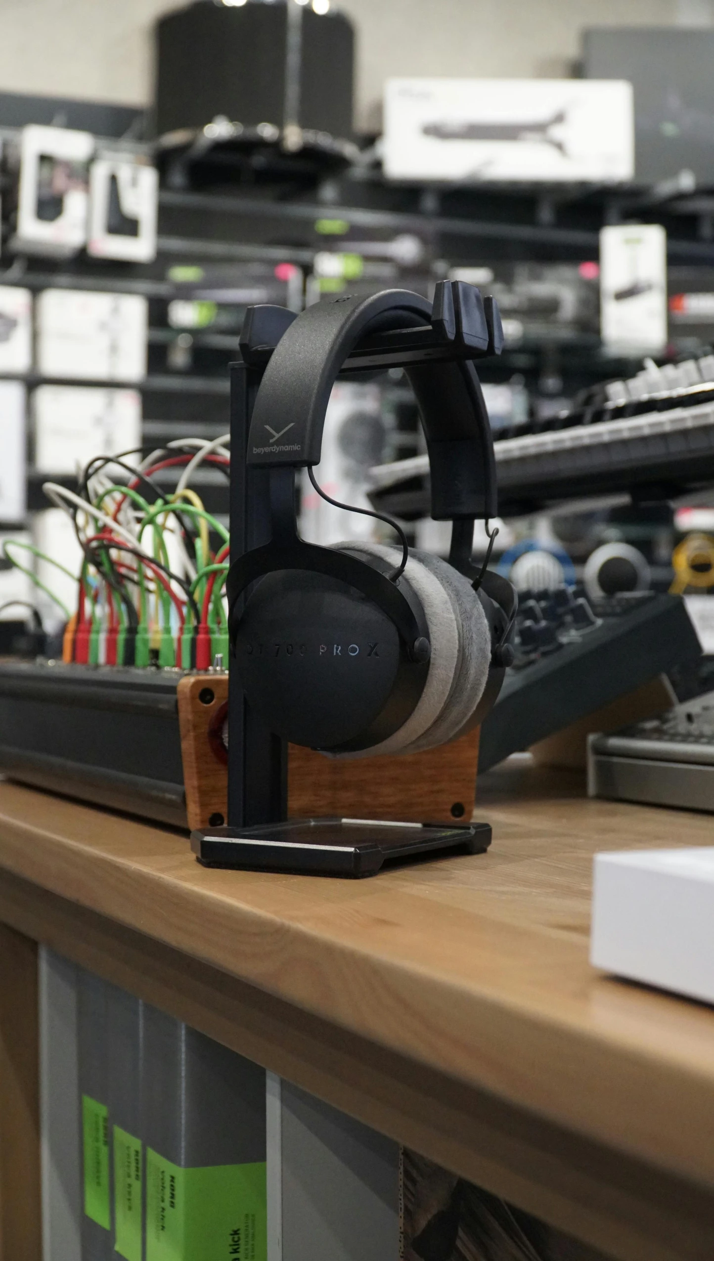 a pair of headphones sitting on top of a wooden table, rack, adafruit, portrait n - 9, v 8 k