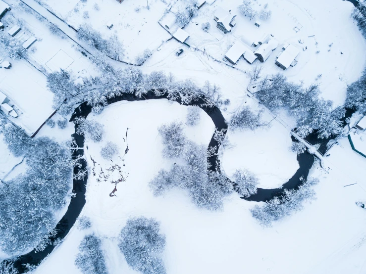 a river running through a snow covered forest, by Adam Marczyński, pexels contest winner, helicopter view, thumbnail, white, festivals