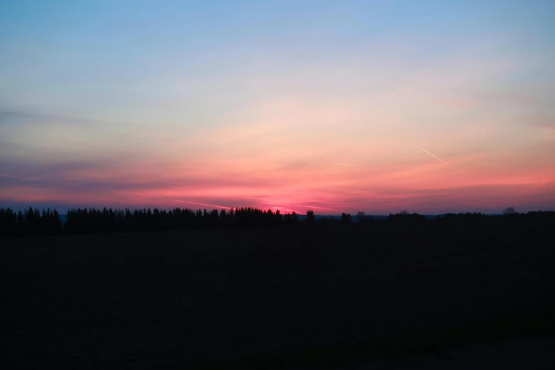 a sunset over a field with trees in the distance, by Attila Meszlenyi, happening, the sky is pink, instagram picture, cinematic shot ar 9:16 -n 6 -g, landscape photograph