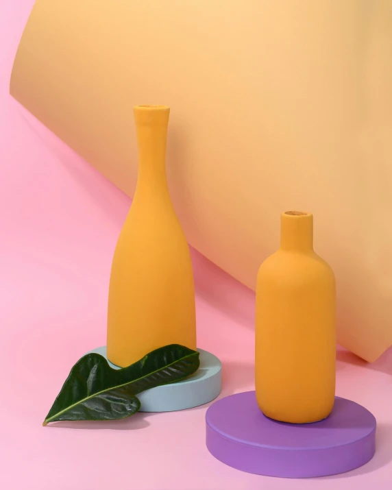 a couple of vases sitting on top of a table, yellow, holding a bottle, matte finish, matte photo