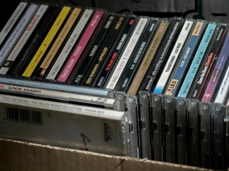 a bunch of cds stacked on top of each other, an album cover, by Everett Warner, unsplash, cigarrette boxes at the table, rack, museum collection, computer music