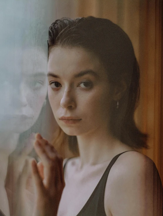 a woman standing in front of a window, inspired by Elsa Bleda, pexels contest winner, hyperrealism, portrait sophie mudd, blur effect face, with a mirror, asian woman