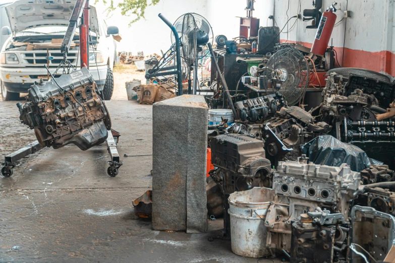 a man working on a car engine in a garage, a portrait, unsplash, assemblage, pile of bodies, an abandoned old, background image, brown