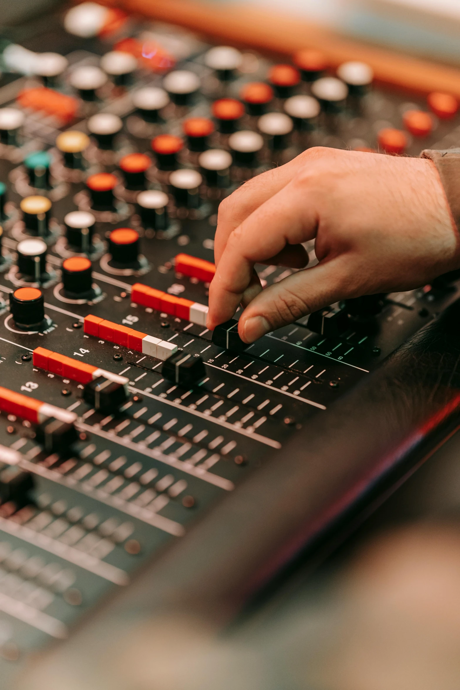 a close up of a person's hand on a mixing board, an album cover, pexels, electronic circuitry, ilustration, people at work, studio orange