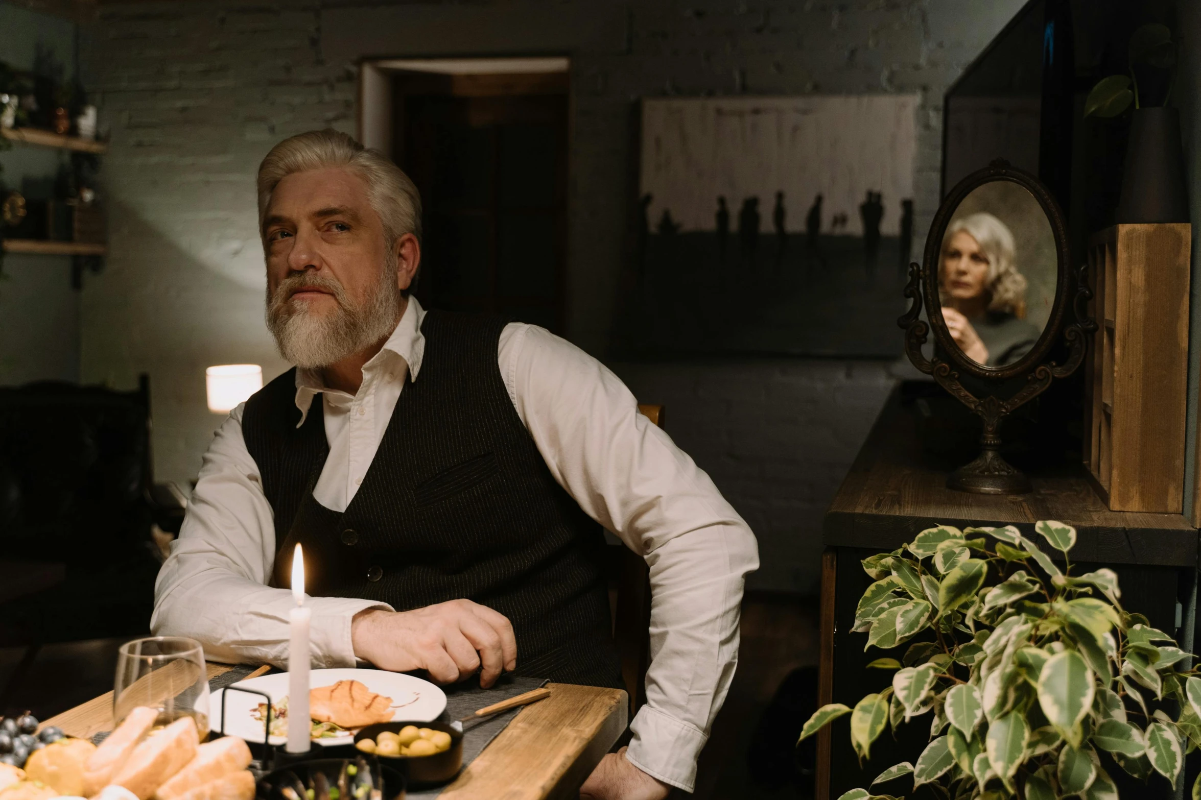 a man sitting at a table with a plate of food, by Emma Andijewska, pexels contest winner, fantastic realism, silver hair and beard, kramskoi 4 k, ( ( theatrical ) ), celebrating a birthday