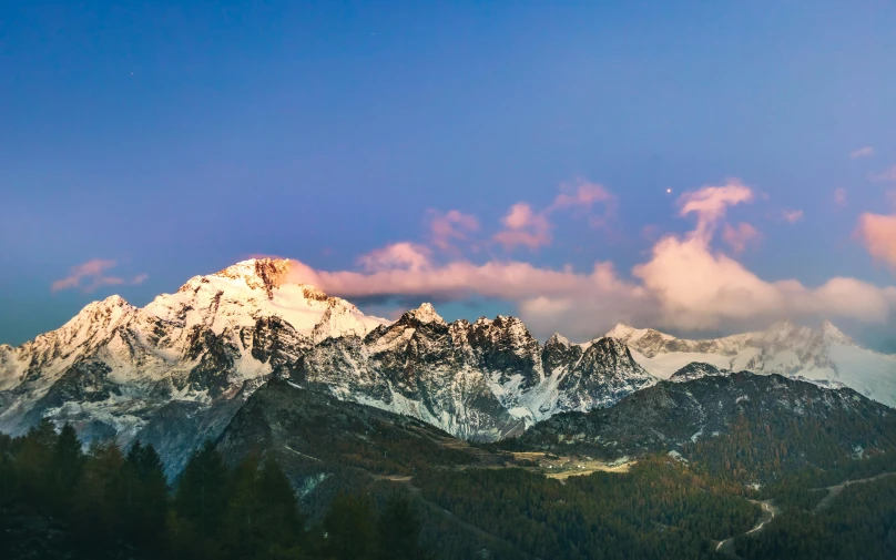 a mountain covered in snow next to a forest, pexels contest winner, early evening, larapi, panoramic, fan favorite