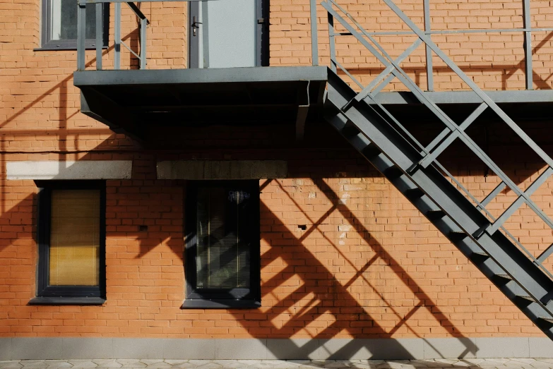 a red fire hydrant sitting in front of a brick building, inspired by Bauhaus, unsplash, stairs to an upper floor, фото девушка курит, evening sunlight, graphite