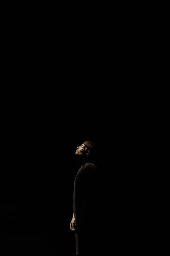a man standing in the dark looking up, by Zsolt Bodoni, minimalism, drake, stage photography, spock, muhammad ali