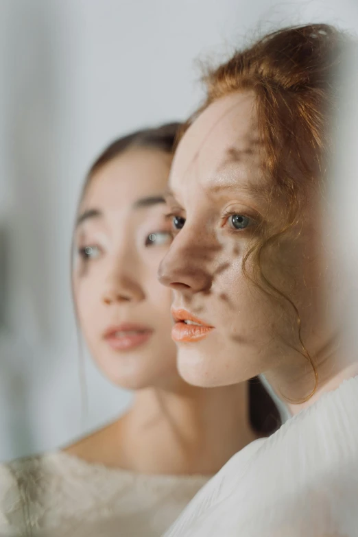 a couple of women standing in front of a mirror, trending on pexels, hyperrealism, ginger hair with freckles, asian features, square facial structure, ethereal and otherworldly