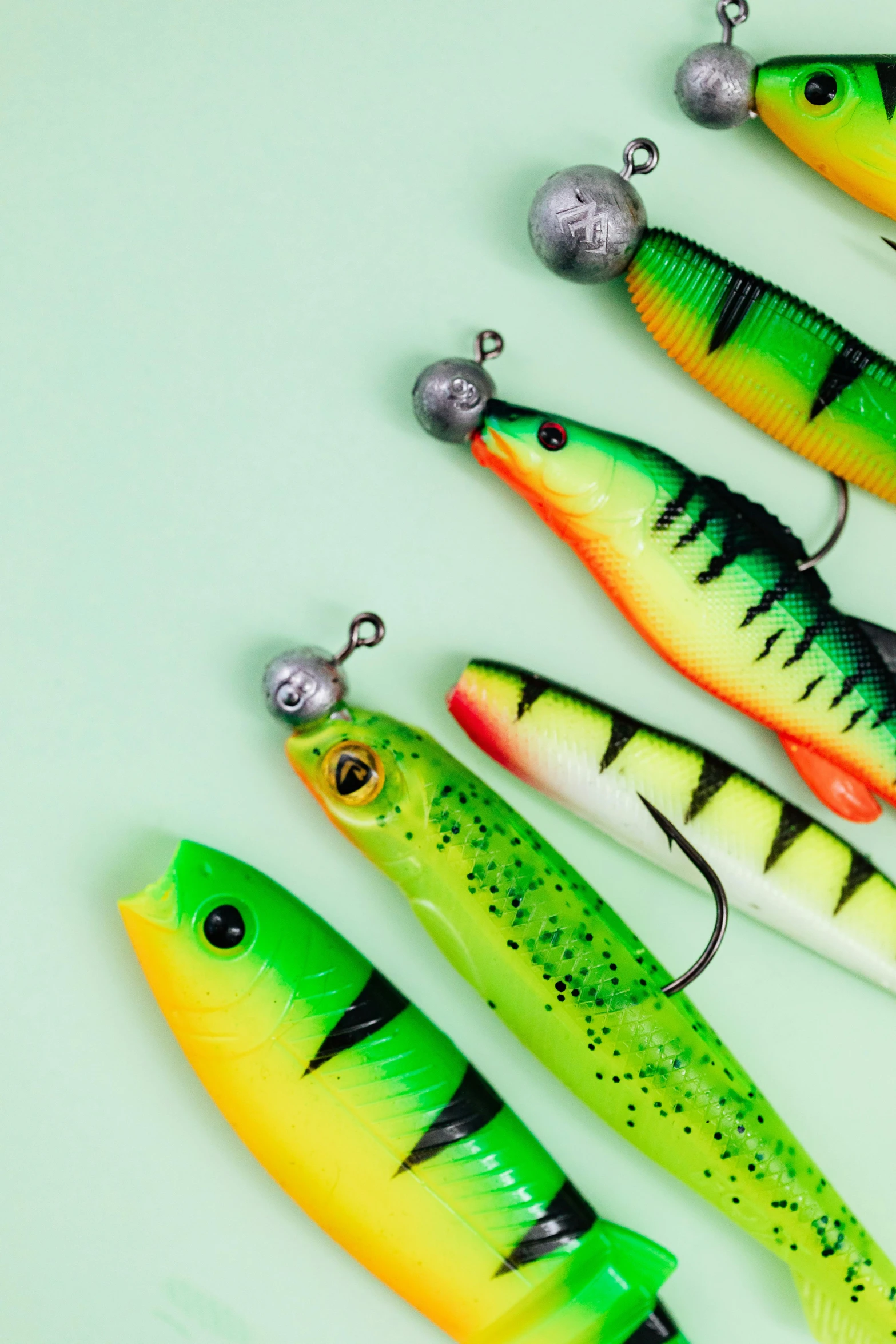 a group of fishing lures sitting next to each other, green and yellow, modelling, dramatic product shot, lush