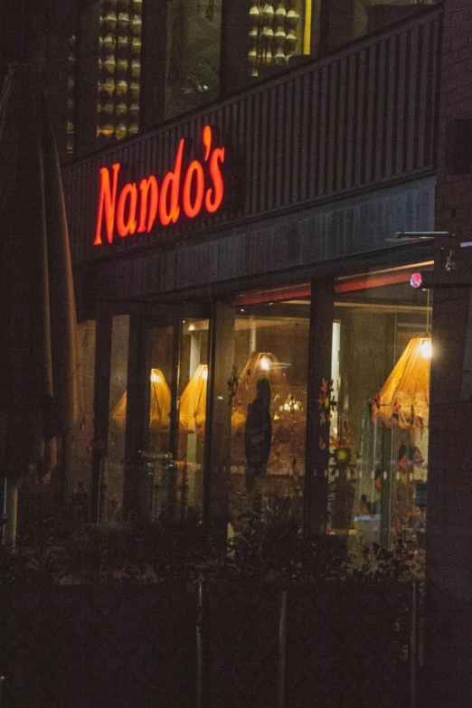 a restaurant with a neon sign that says nando's, by Dennis Flanders, graffiti, window to night time, where's waldo, promo image, standoff