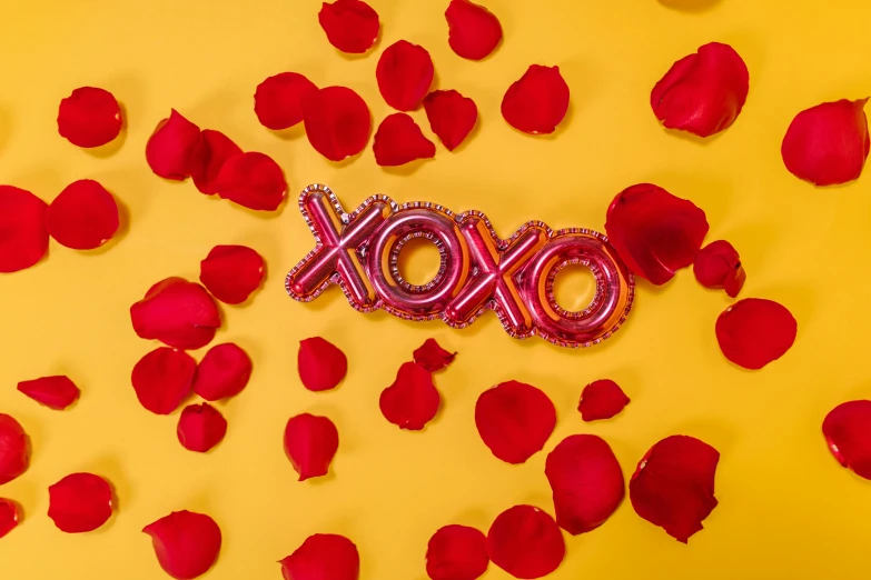 a red xoxo balloon surrounded by rose petals, by Julia Pishtar, pexels contest winner, yellow red scheme, 🎀 🗡 🍓 🧚, foil, charli xcx