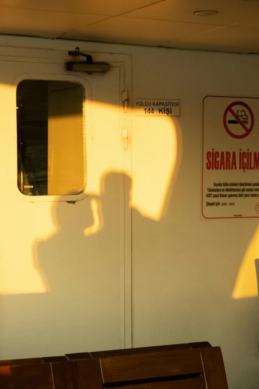 a couple of benches sitting next to each other, by Ibrahim Kodra, shaft of sun through window, on ship, shadow of beard, signs