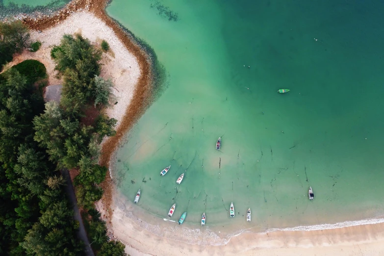 a group of boats floating on top of a body of water, pexels contest winner, beach aesthetic, green water, thumbnail, 1 2 9 7