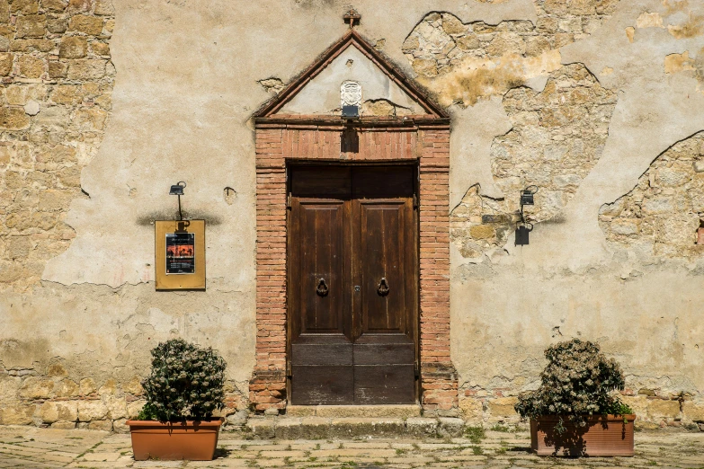 a brown door sitting on the side of a building, an album cover, by Marcello Bacciarelli, pexels contest winner, renaissance, farmhouse, square, the narthex, shop front