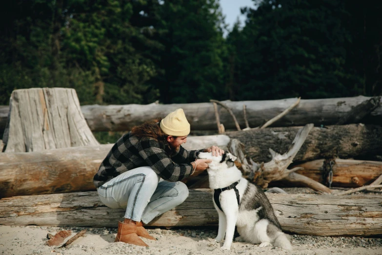 a woman is petting a husky dog on the beach, trending on pexels, visual art, lumberjack, sitting on a log, avatar image, a handsome