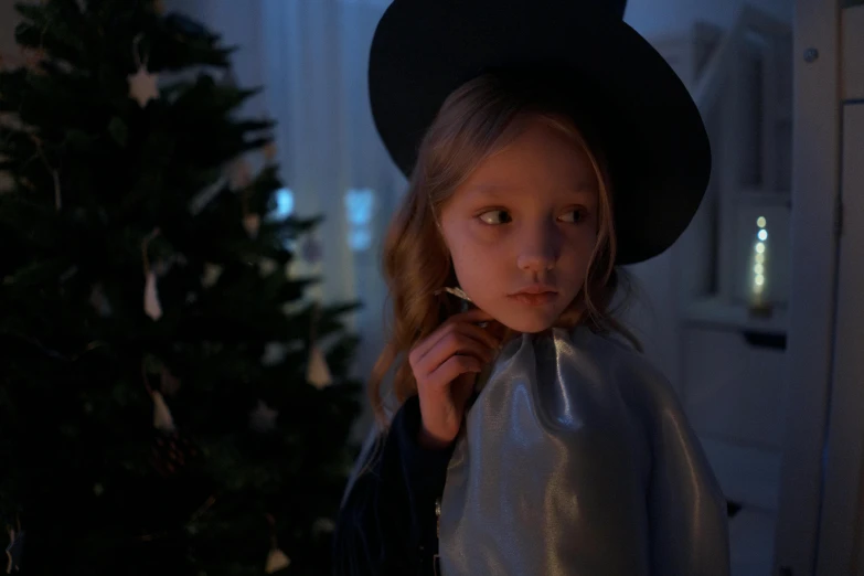 a little girl dressed up in a witch costume, an album cover, inspired by Gottfried Helnwein, pexels contest winner, christmas night, maika monroe batgirl, ( ( theatrical ) ), stålenhag