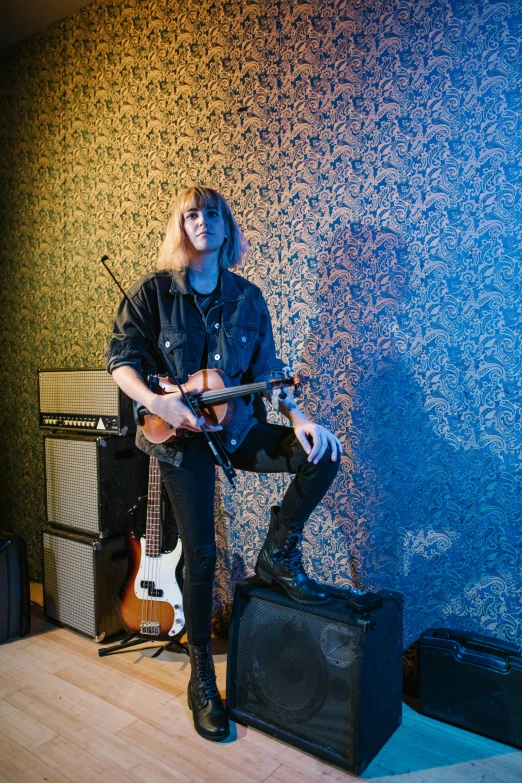 a man that is playing a guitar in a room, an album cover, inspired by Lasar Segall, unsplash, private press, blond, cai xukun, full-body, looking threatening