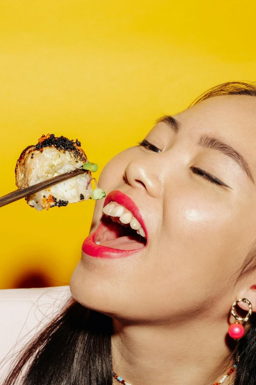 a woman eating sushi with a pair of chopsticks, by Julia Pishtar, trending on pexels, pop art, with gold teeth, kiko mizuhara, food stylist, square