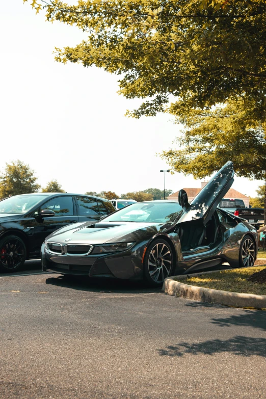 a couple of cars parked next to each other in a parking lot, bmw i 8, upon a peak in darien, slide show, j. h. williams iii