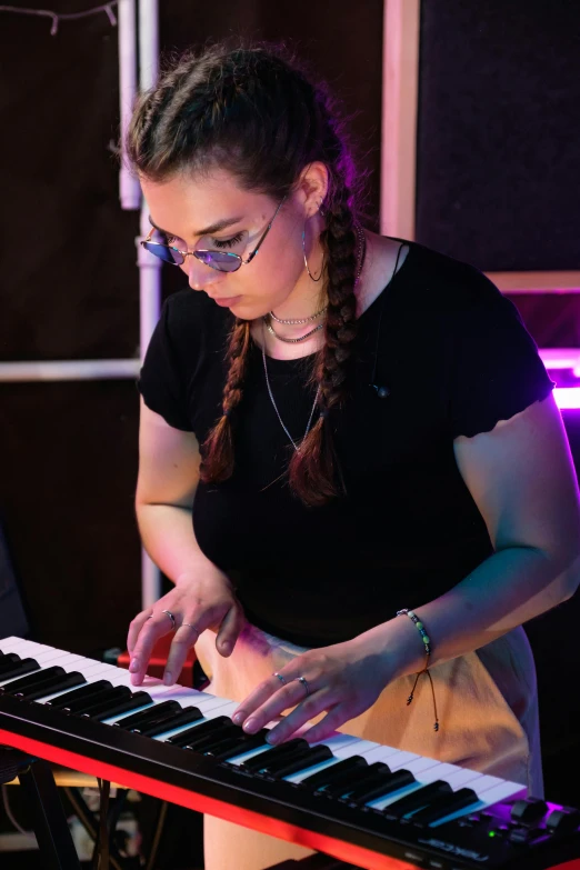 a woman standing in front of a keyboard, charli bowater, profile image, plays music, student