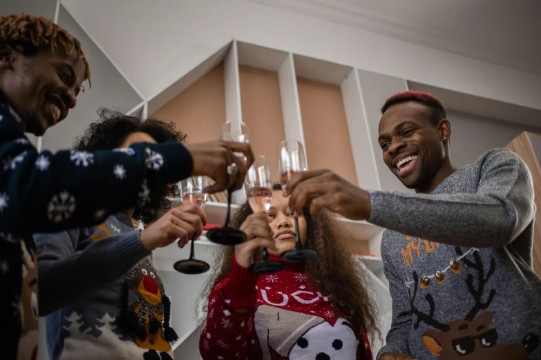 a group of people toasting with wine glasses, a cartoon, pexels contest winner, happening, wearing festive clothing, black man, families playing, mid shot photo