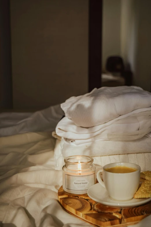 a tray sitting on top of a bed next to a cup of coffee, by Elsa Bleda, renaissance, natural candle lighting, white and gold robes, stacked image, low - angle shot