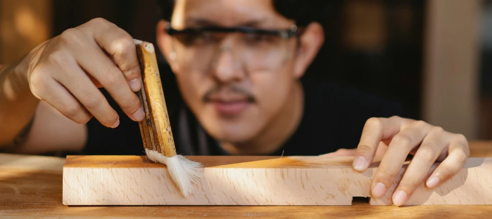 a close up of a person cutting a piece of wood, inspired by Kanō Shōsenin, arts and crafts movement, thumbnail, jon kuo, portrait, rectangle