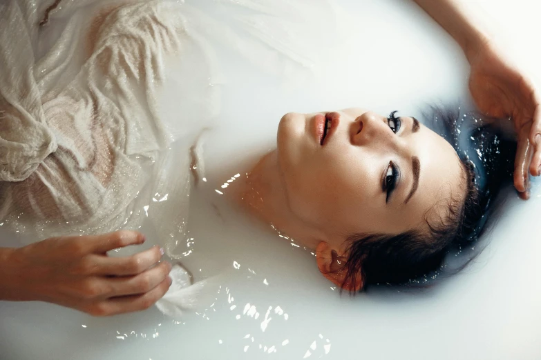 a woman taking a bath in a bathtub, inspired by Elsa Bleda, trending on pexels, process art, brunette woman, inflatable, pearlescent skin, liquid headdress