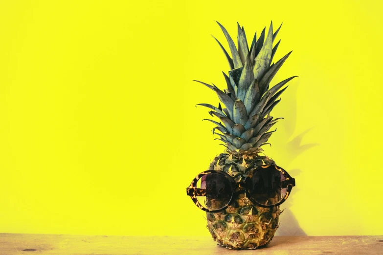 a pineapple with sunglasses sitting on a table, an album cover, pexels, yellow skin, profile pic, cooling, ready to eat
