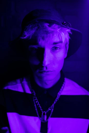 a close up of a person wearing a hat, a portrait, unsplash, digital art, cool purple lighting, robert sheehan, a blond, dayglo