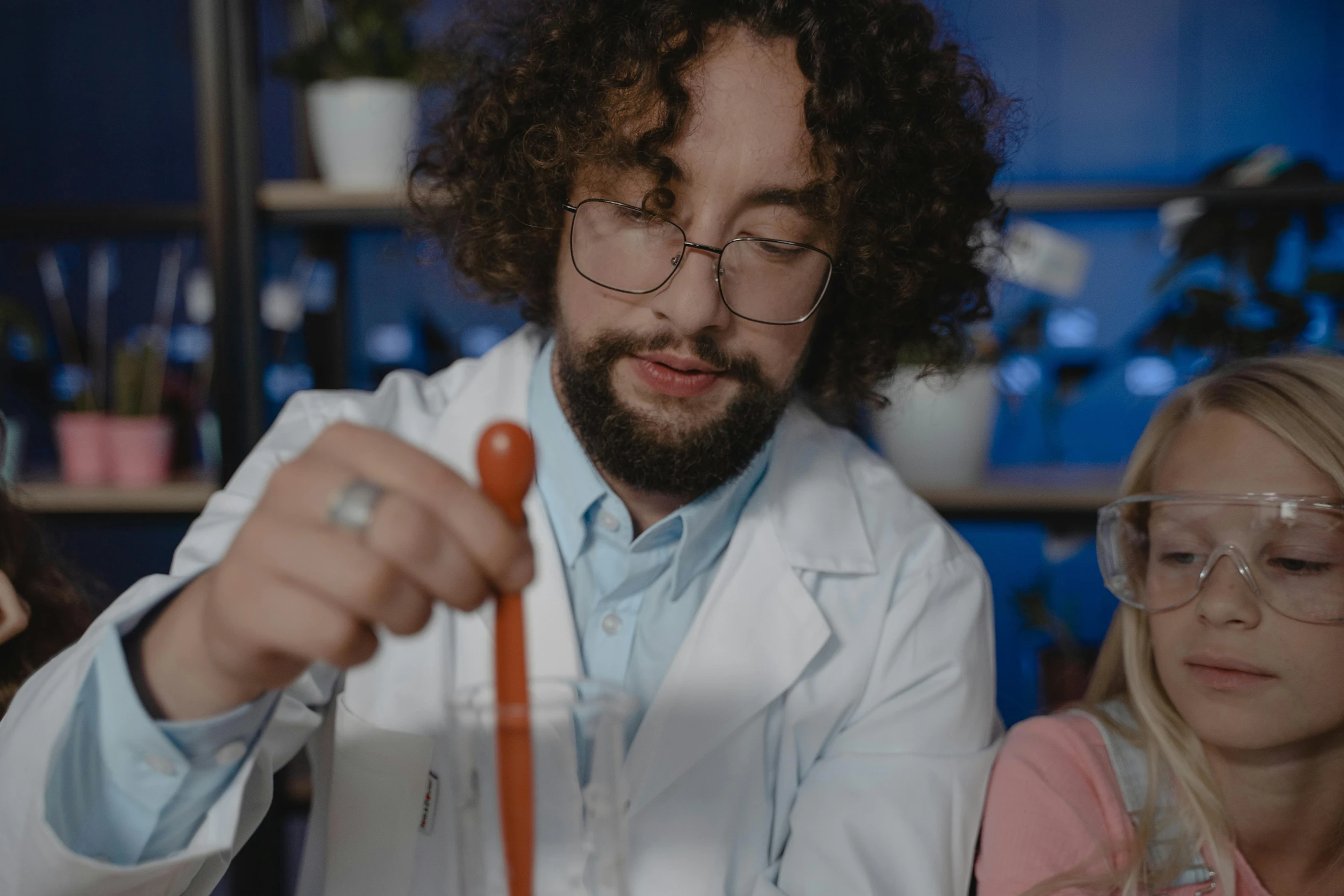 a man in a lab coat pouring something into a beakle, a portrait, trending on pexels, nerd, thumbnail