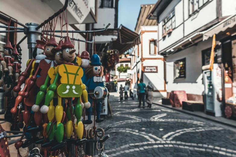 a street filled with lots of different colored figurines, pexels contest winner, transylvania, 🦩🪐🐞👩🏻🦳, turkey, avatar image