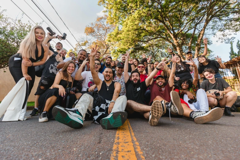 a group of people sitting on the side of a road, ecstatic crowd, são paulo, avatar image, threyda