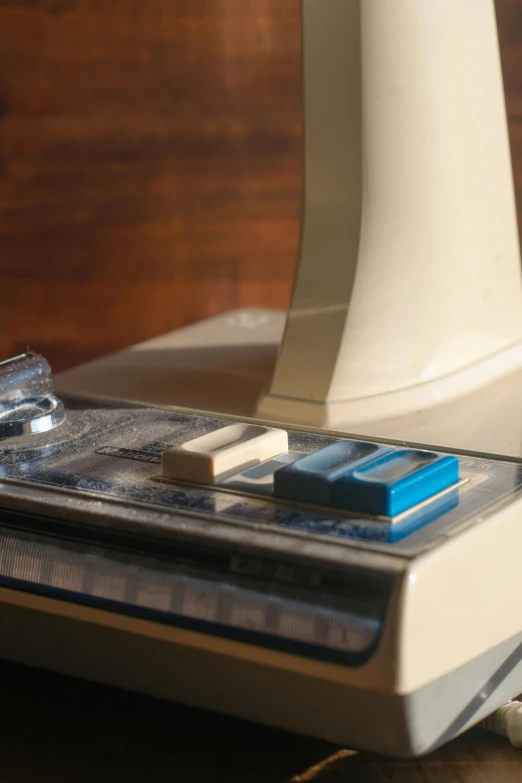 a blender sitting on top of a wooden table, 1 9 8 0 s computers, cream and blue color scheme, up-close, resin