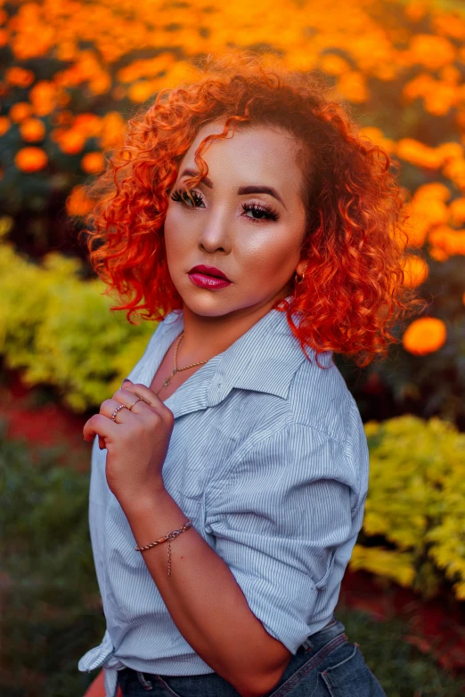 a woman with red hair standing in a field of flowers, a portrait, trending on pexels, orange lights, curls hair, casual pose, contrasted color